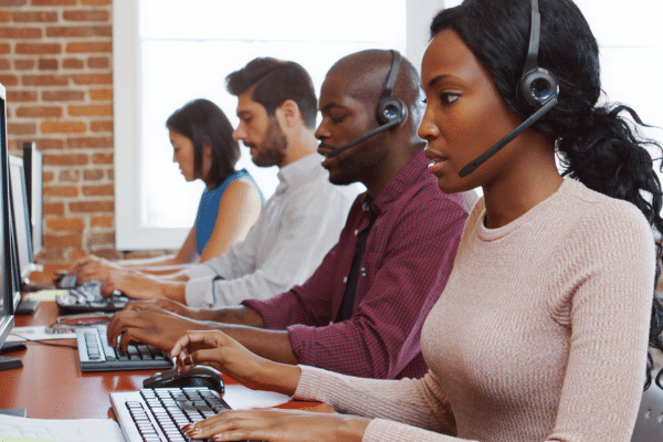 Customer service team at work - featured image for Customer Service Week Ideas That Create Better Customer Experiences by Brittany Hodak